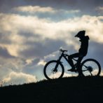 silhouette of person riding on bicycle during daytime